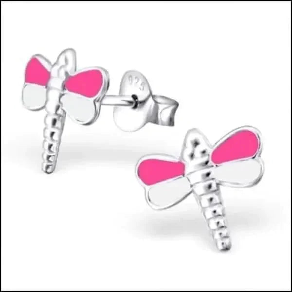 a pair of pink scissors sitting on top of a white table