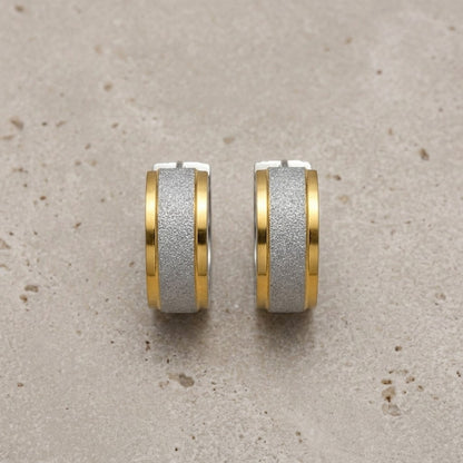 Aramat Jewels bicolor sandblasted stainless steel hoop earrings with a gold stripe detail.