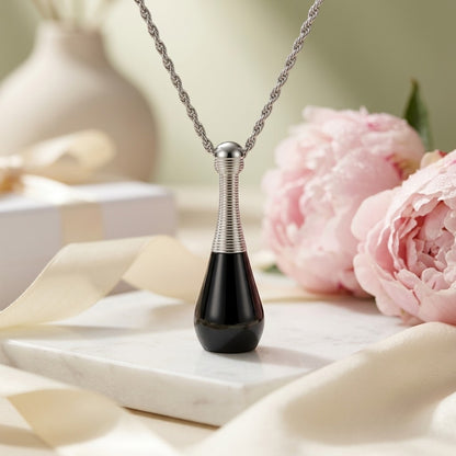 Aramat Jewels black and silver cone-shaped cremation urn pendant necklace made of 316L stainless steel, 4cm long.