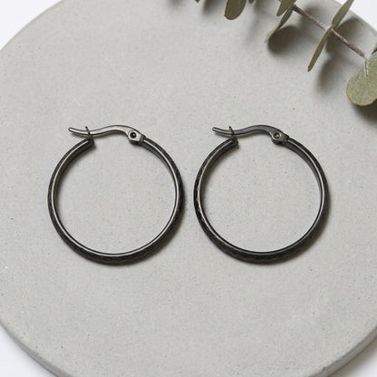 Aramat Jewels black stainless steel hoop earrings with a 30mm diameter and a subtle diamond pattern.