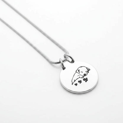 Aramat Jewels silver and black stainless steel dog ash pendant with chain, featuring a sleeping puppy design.