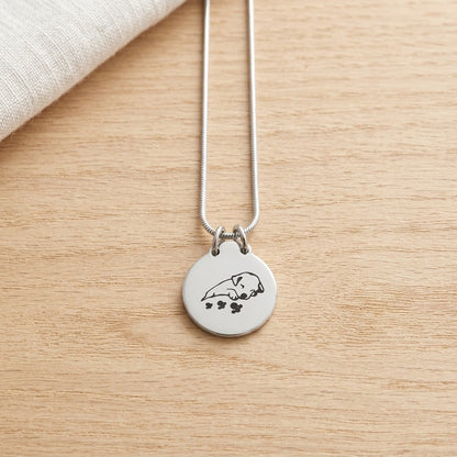 Aramat Jewels silver stainless steel dog ash pendant with paw prints and a sleeping dog engraving, 2.5cm, with a 50cm snake chain.