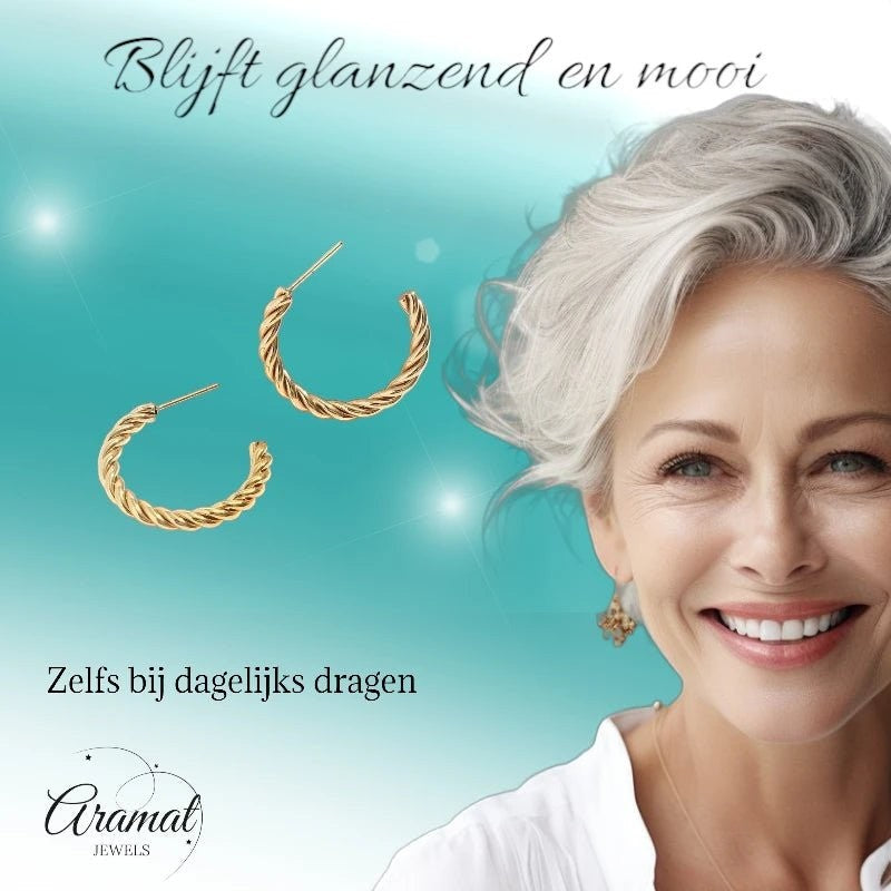 Aramat Jewels goudkleurige twisted halve hoepel oorbellen van roestvrij staal, gedragen door een stralende vrouw.