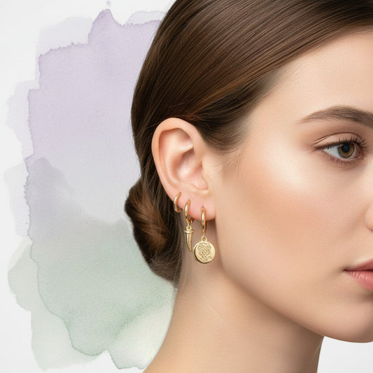Aramat Jewels gold-plated 925 silver hoop earrings set with animal charms: horn, leopard, owl, elephant, turquoise stone, and leaf.
