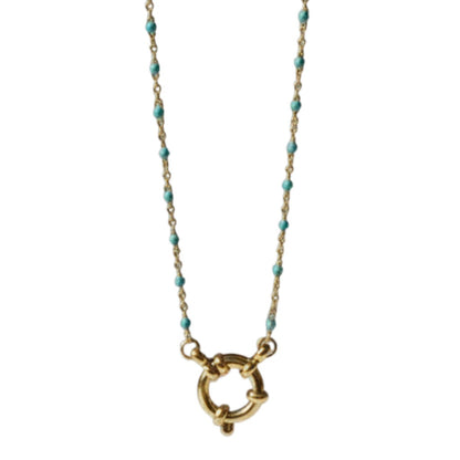 Aramat Jewels gold chain necklace with small blue enamel beads and a circular clasp, displayed on a branch.