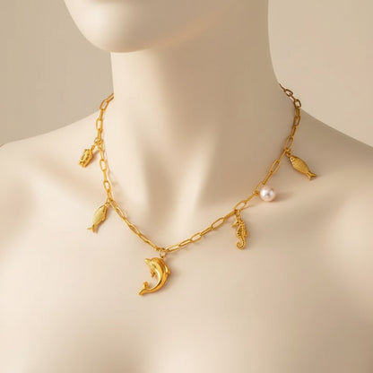 Aramat Jewels gold-tone stainless steel necklace with sea-themed charms: dolphin, turtle, fish, and a pearl. 45 cm.