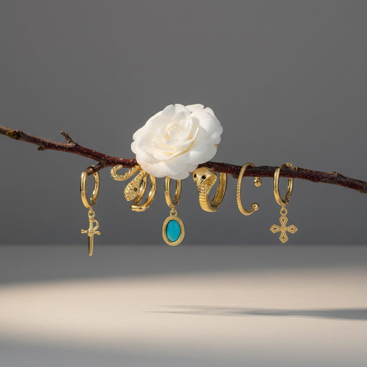 Aramat Jewels gold-plated 925 silver earring set with charms: sword, turquoise oval, snake, twisted hoop, and cross.