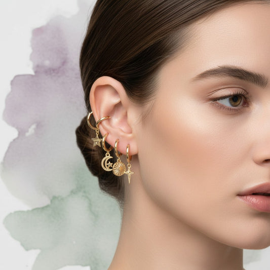 Aramat Jewels set of 6 gold plated 12mm hoop earrings with charms: star, moon, sun, cross, and crystal.