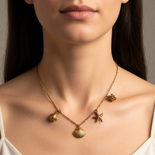 Aramat Jewels gold-tone Singapore chain necklace with shell, crab, starfish, and turtle charms.