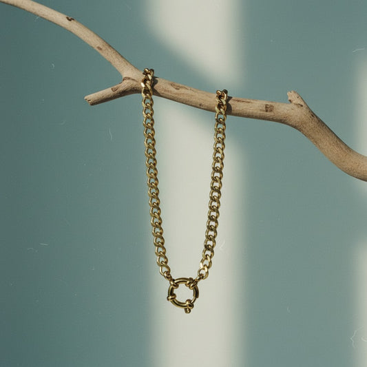 Aramat Jewels gold-colored stainless steel gourmet link charm necklace with a circular clasp.