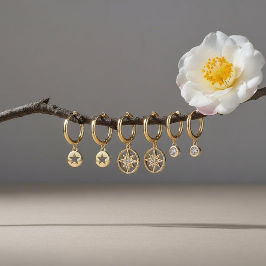 Aramat Jewels set of 3 pairs of gold-plated 925 silver hoop earrings with star and zirkonia charms.