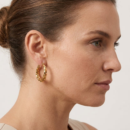 Aramat Jewels gold-tone twisted triple hoop earrings, 25x7mm, with a comfortable hinge closure.