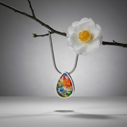 Aramat Jewels teardrop pendant with colorful Murano glass floral inlay, made of 316L stainless steel.