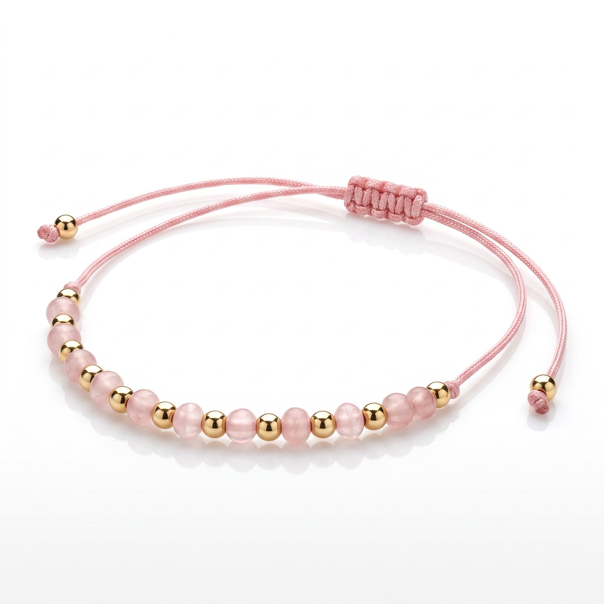 Aramat Jewels roze enkelbandje met 5mm cats eye kralen en goudkleurige accenten, verstelbaar met schuifknoop.
