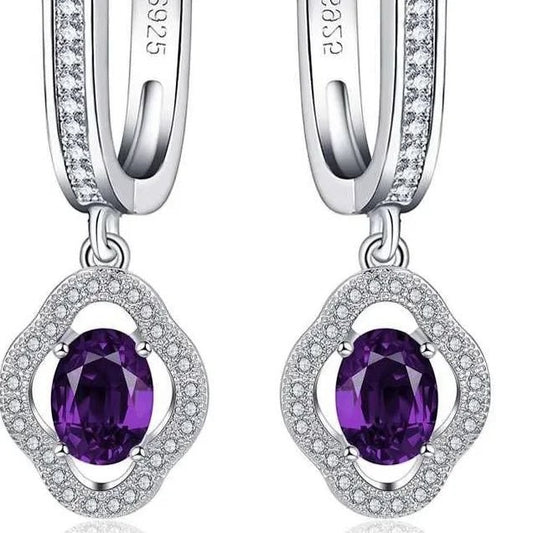 Aramat Jewels silver hoop earrings with flower charm, featuring a purple oval zirconia stone surrounded by clear crystals.