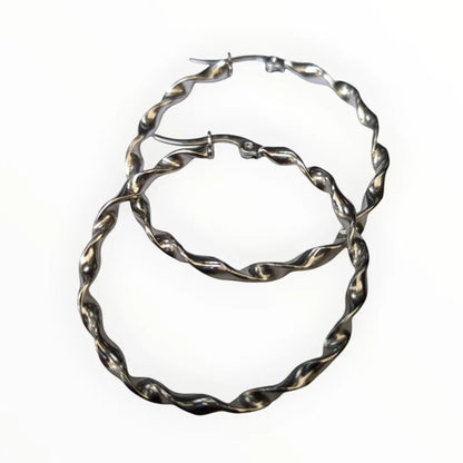 Aramat Jewels silver-tone stainless steel twisted hoop earrings, 40mm diameter, high gloss finish.