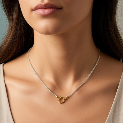 Aramat Jewels white and transparent beaded necklace with gold clasp, worn by a model.