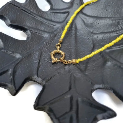 Aramat Jewels yellow seed bead necklace with gold clasp and accents, 42cm length.