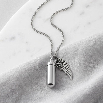Aramat Jewels zilverkleurige ashanger met vleugel en roos, van roestvrij staal. Gedenksieraad met schroefsluiting.